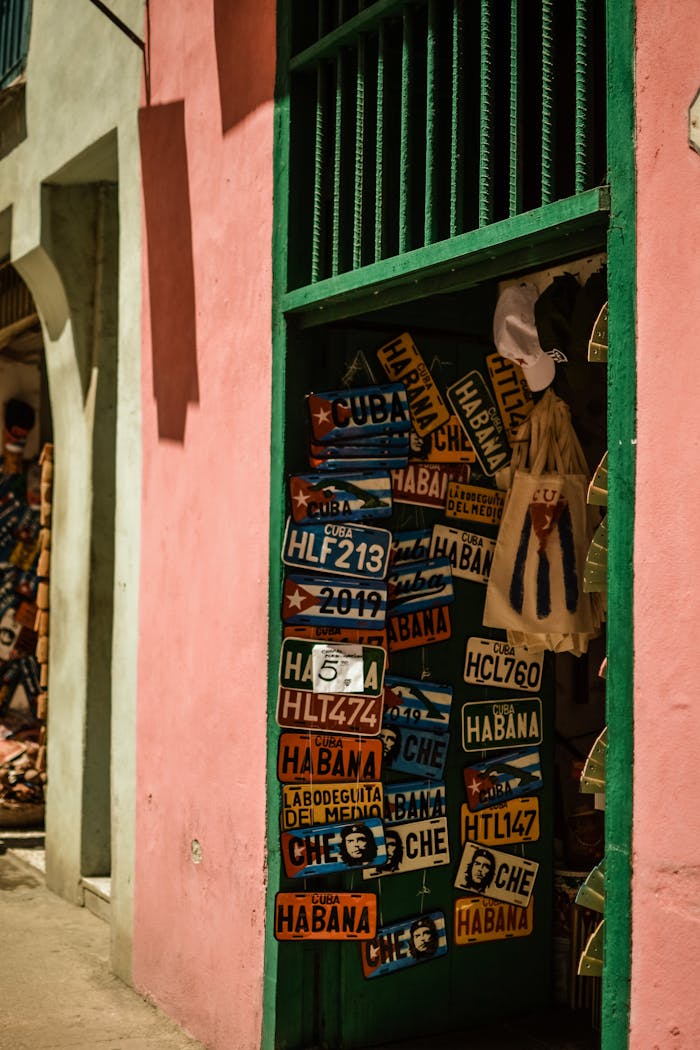 Offerings Vibrant display of Cuban license plates in a souvenir shop doorway in Havana.