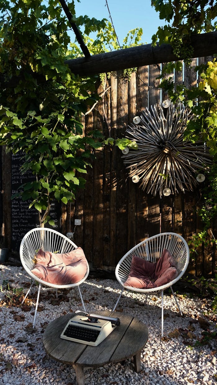 Stylish garden setting with chairs, a vintage typewriter, and artistic decor in Urla, İzmir.
